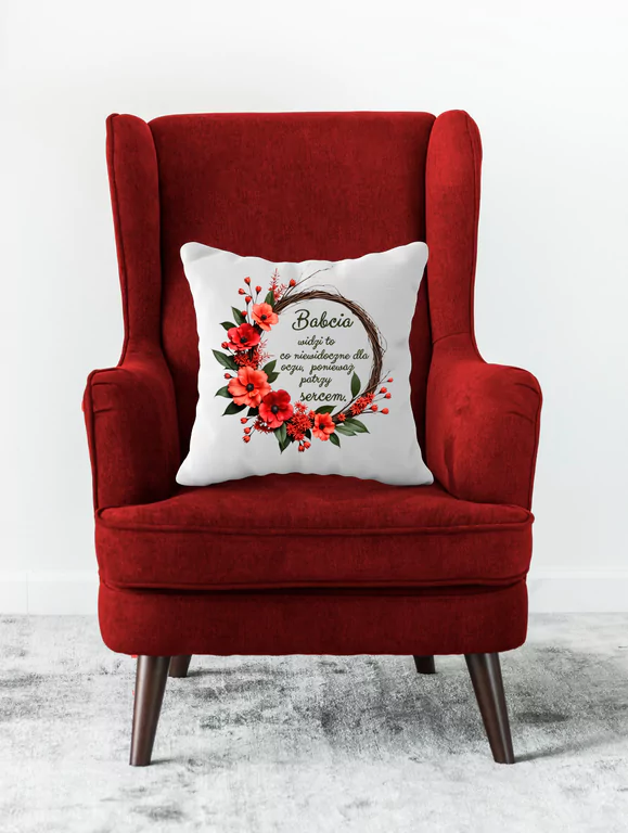 Makowy Wianek – Poduszka 40x40 cm Dla Babci która opiera się na czerwonym fotelu jako dekoracja