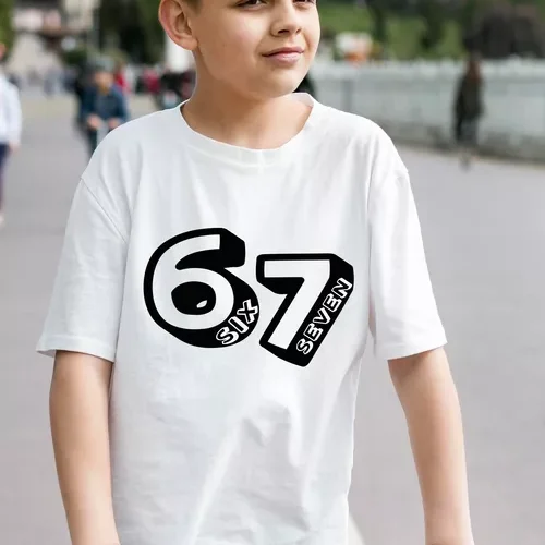 Chłopiec w białej bawełnianej koszulce z czarnym nadrukiem '67 SIX SEVEN', siedzący na hulajnodze, symbolizujący swobodę i aktywność.